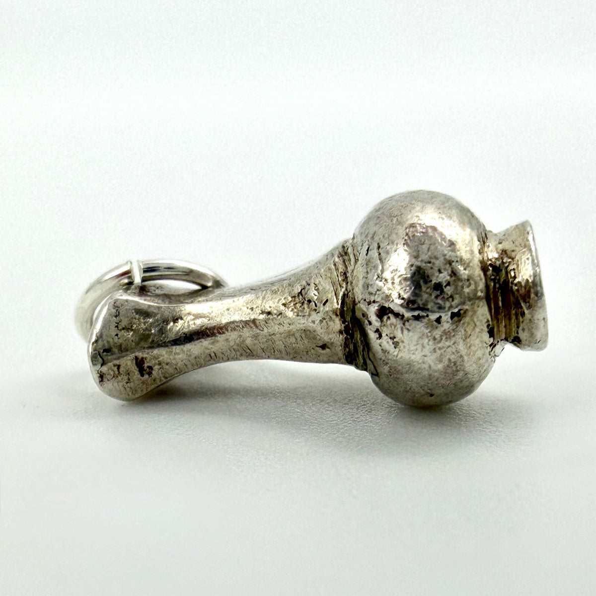 Front view of vintage sterling silver water jug charm showing handle and loop