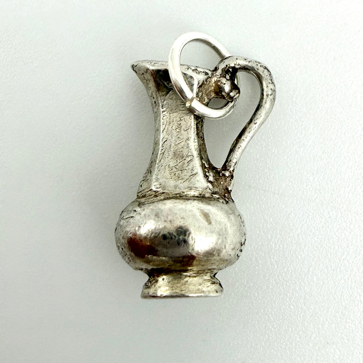 Aquarius water jug charm beside card showing weight 3.47g, length 16mm and width 9mm