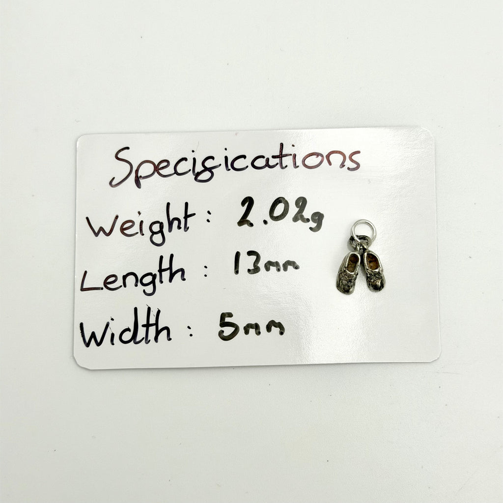 A small silver shoe charm with a keyring is displayed next to a white card that lists its specifications: weight 2.02g, length 13mm, and width 5mm.