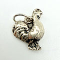 A sterling silver rooster charm pendant with a textured finish and a hanging loop, shown on a plain white background.