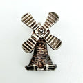 Vintage sterling silver windmill charm beside a ten pence coin for scale