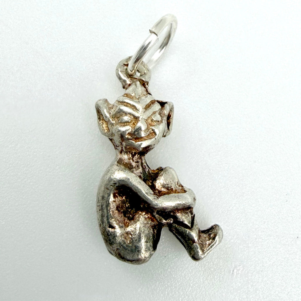 Back view of seated sterling silver imp pixie charm