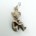 Back view of seated sterling silver imp pixie charm