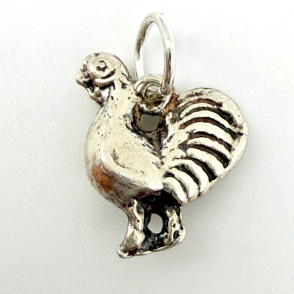 Reverse view showing the feathered tail of the sterling silver cockerel charm