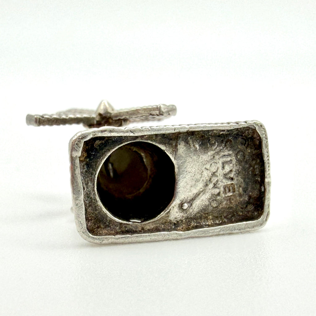 A vintage silver ring featuring a rectangular bezel-set round gemstone, with a textured silver band and a visible 'LOVE' engraving on the inner setting, photographed against a plain white background.