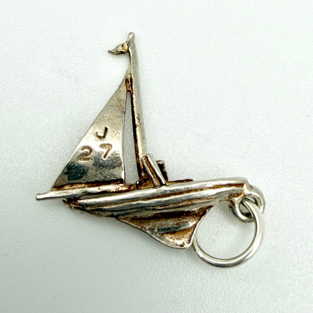 Vintage sterling silver J27 racing sailboat charm front view showing sail detail and jump ring