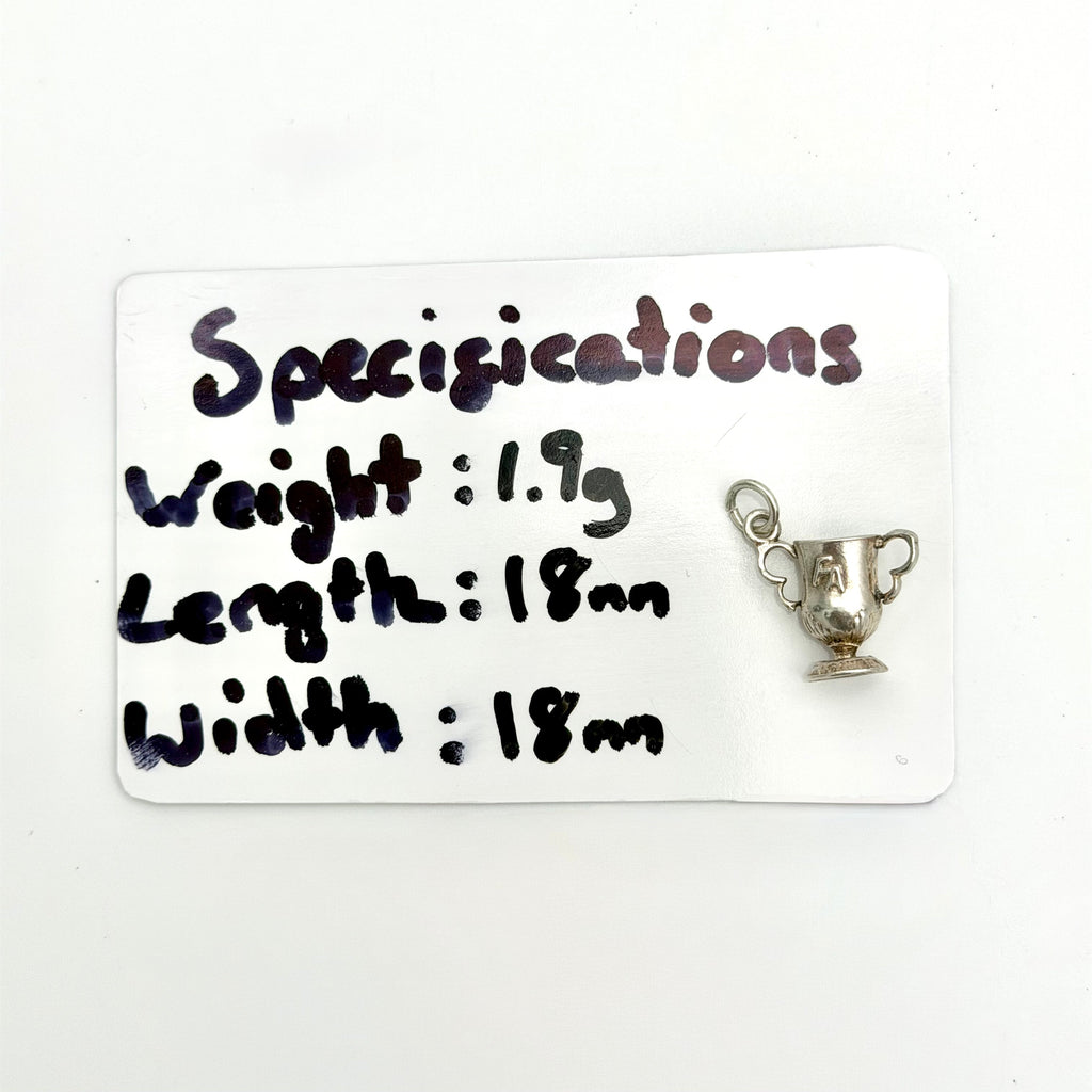 A small silver trophy cup charm with a hanging loop, displayed next to a white card that lists its specifications: weight 1.9g, length 18mm, and width 18mm.