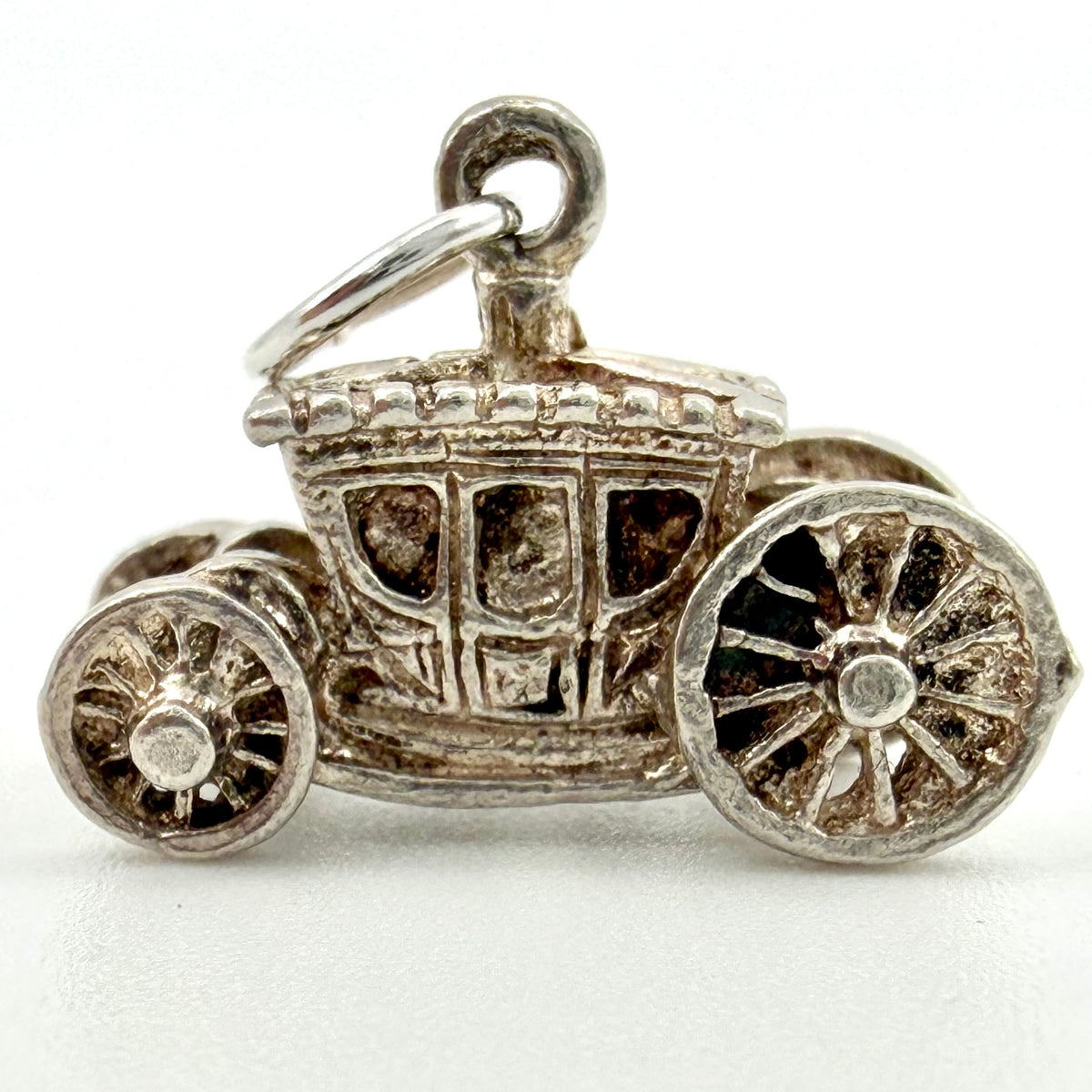 Side view of sterling silver Cinderella carriage charm with detailed windows and wheels