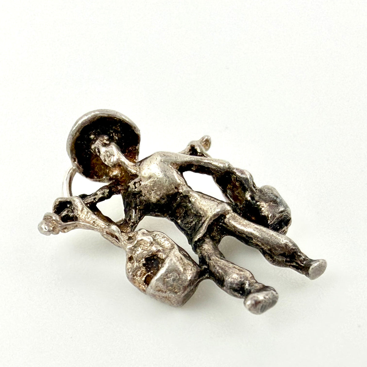 Reverse of silver water carrier charm showing shoulder pole, buckets and jump ring