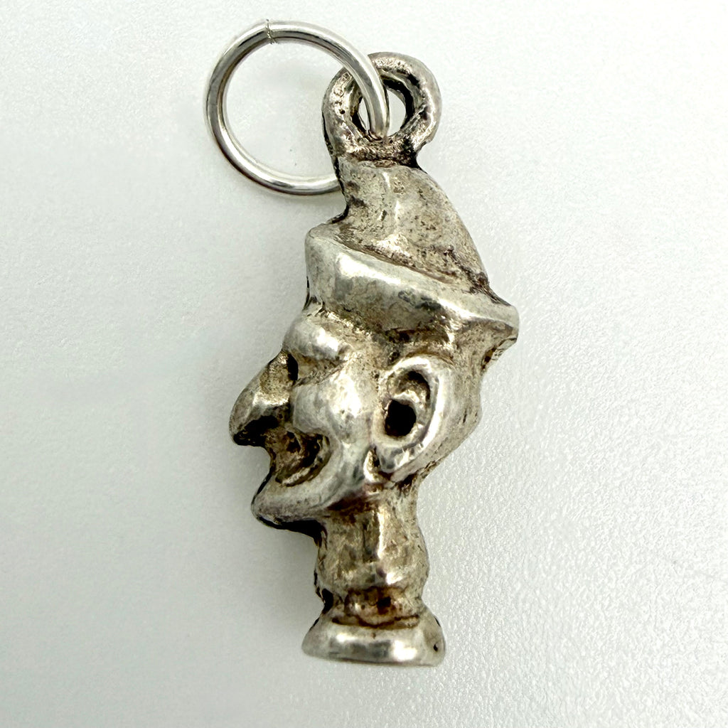 Close up of the reverse of the vintage Mr Punch charm