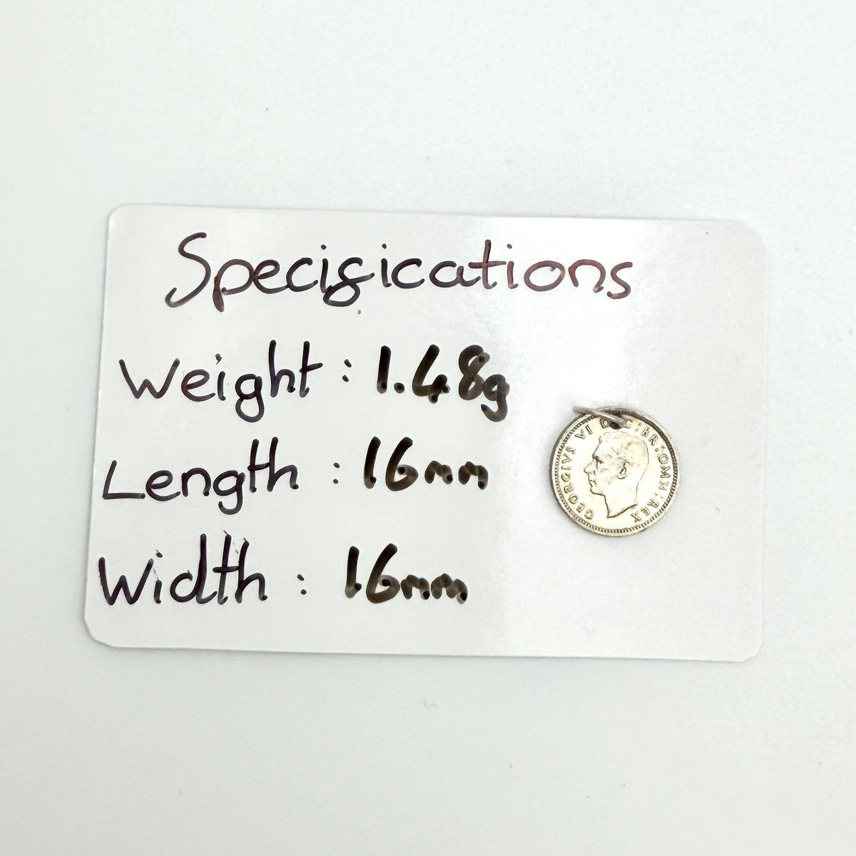 Close view of the 1940 threepence rose and shield design with hanging loop