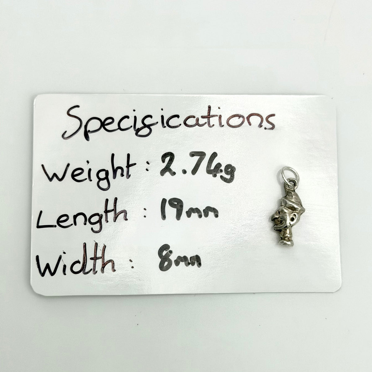 Mr Punch charm with handwritten measurements showing 19mm length, 8mm width and 2.74g weight