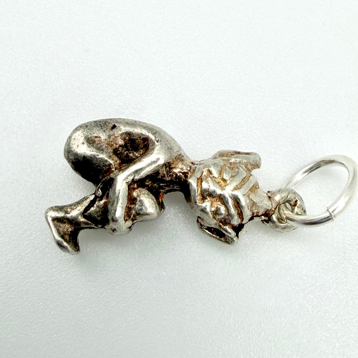 Side view of seated sterling silver imp pixie charm