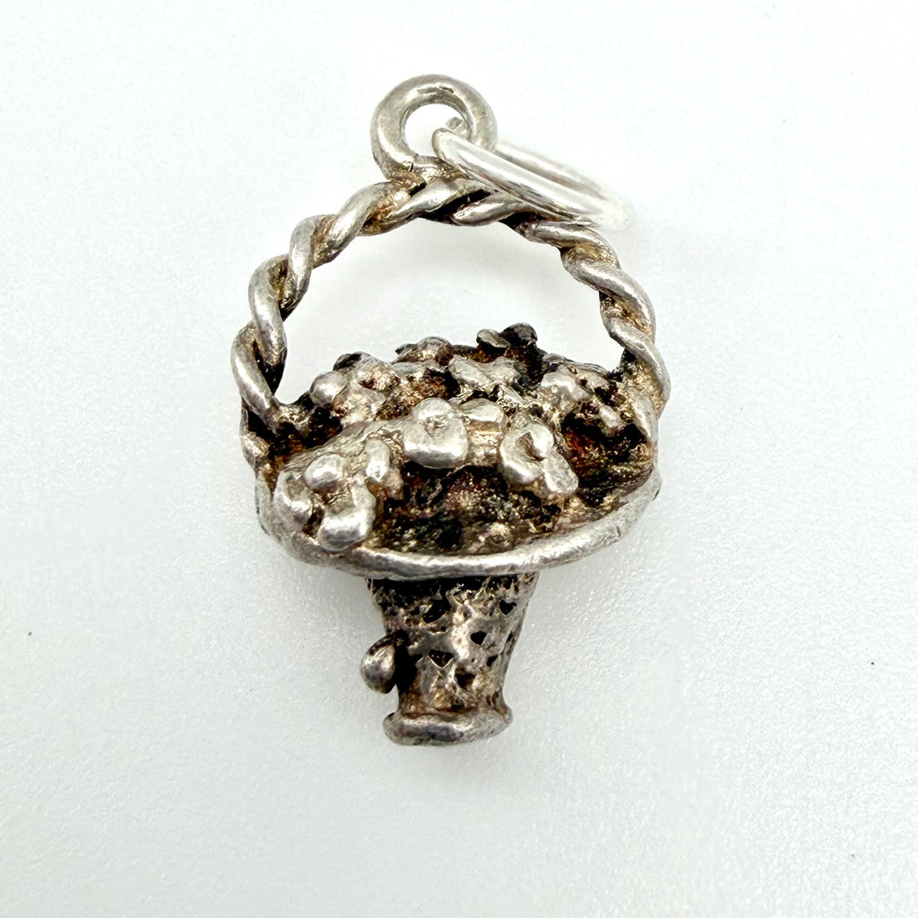 Vintage Sterling Silver Flower Basket Charm with a textured, rustic finish and a twisted stem, shown on a plain white background.