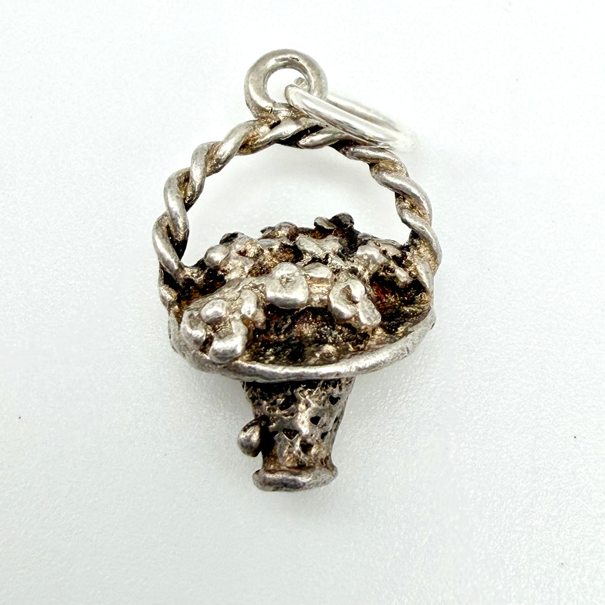 Vintage Sterling Silver Flower Basket Charm with a textured, rustic finish and a twisted stem, shown on a plain white background.