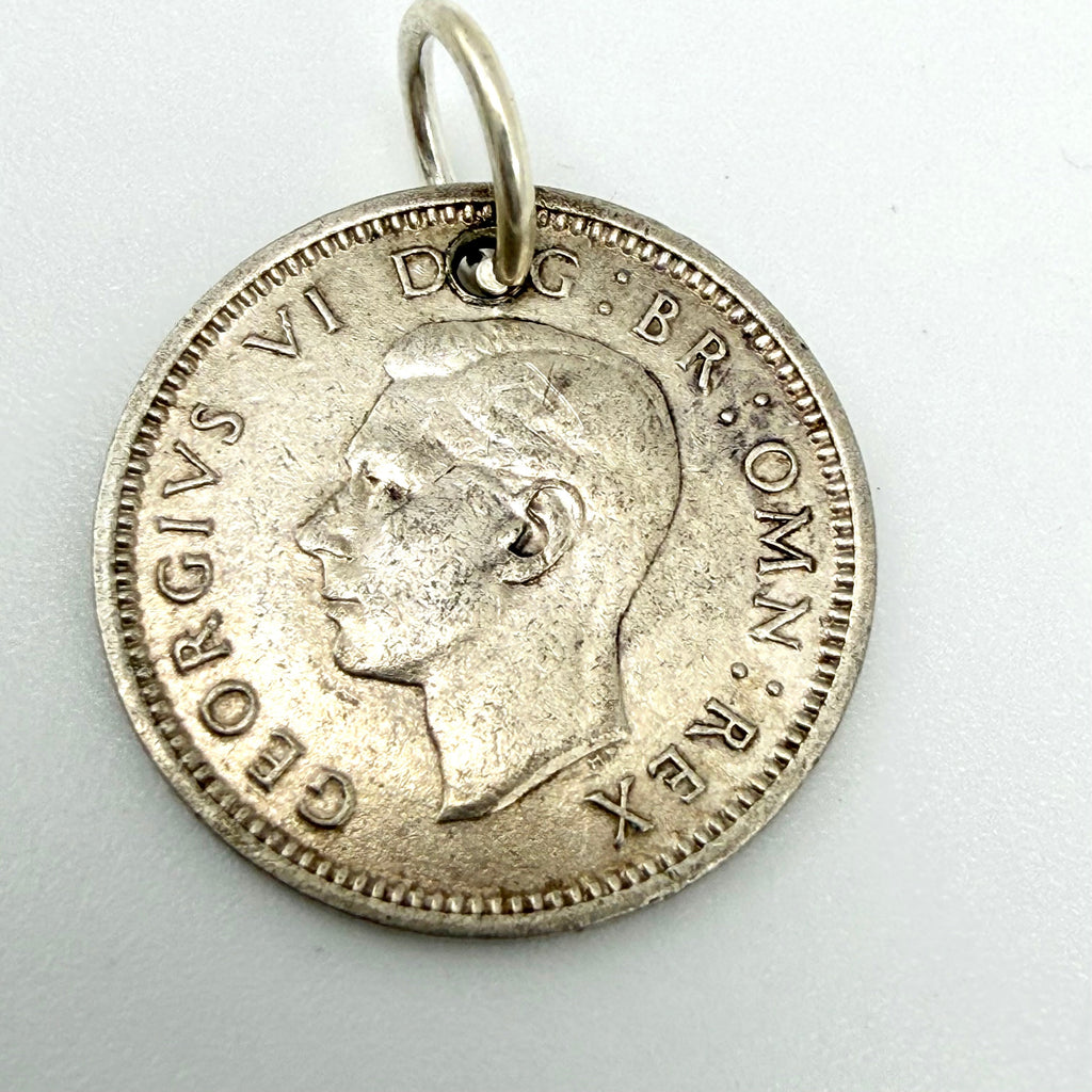 1940 threepence coin charm beside a ten pence coin for scale