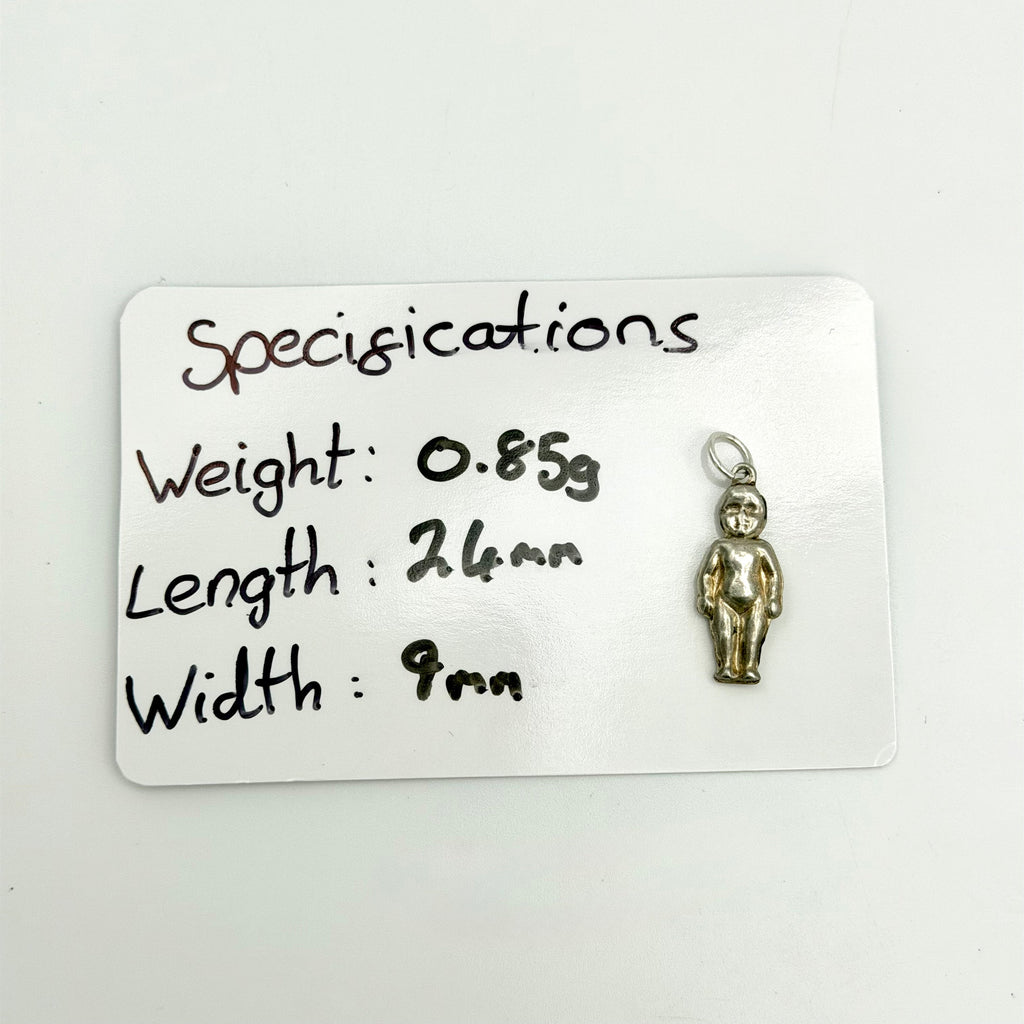 A small metallic pendant shaped like a standing figure, shown next to a white card with handwritten specifications listing weight, length, and width.