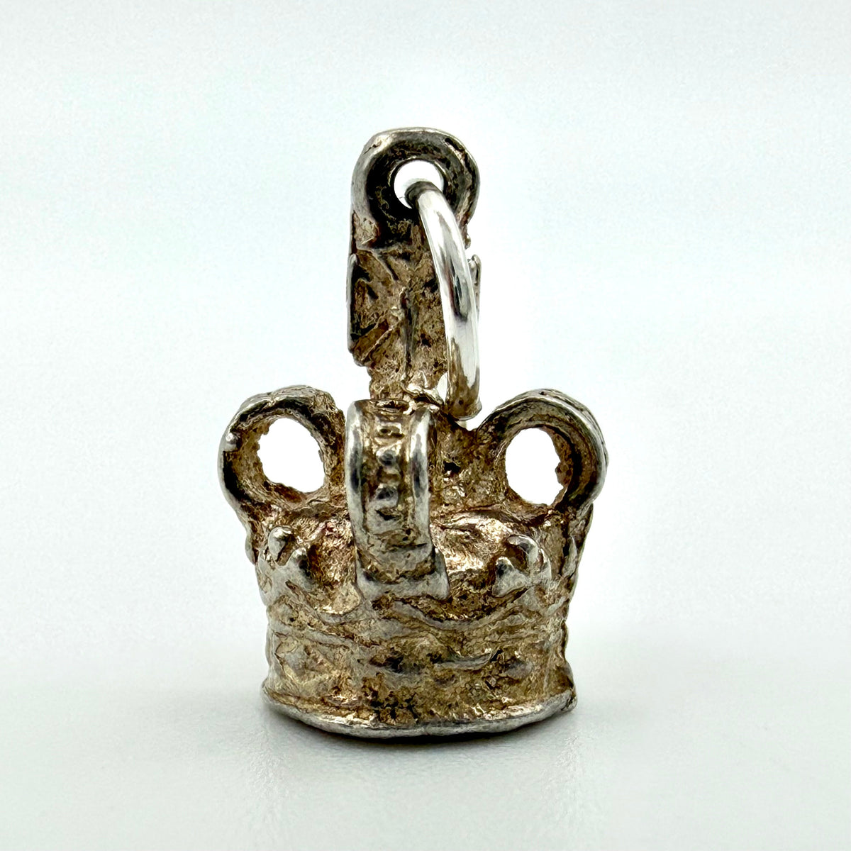 Back of vintage sterling silver crown charm showing the jump ring