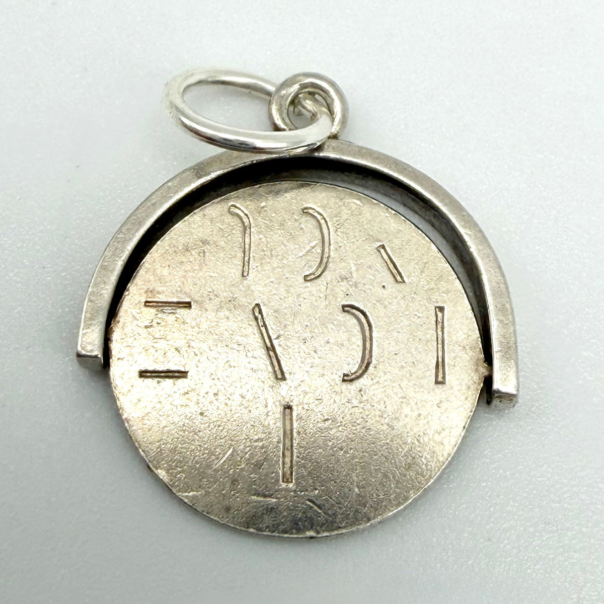 Front view of the sterling silver spinning I Love You fob charm