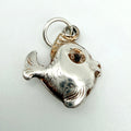Vintage sterling silver fish charm seen from the front with chunky engraved scales, a large round eye, open mouth and a silver suspension ring