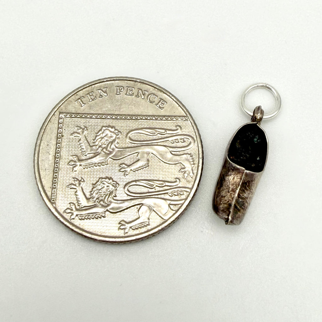 Reverse side of the vintage silver Dutch clog charm showing its aged patina