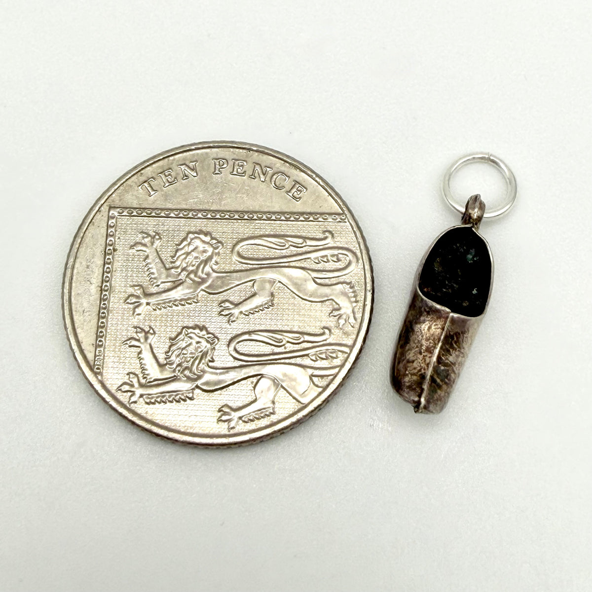 Reverse side of the vintage silver Dutch clog charm showing its aged patina