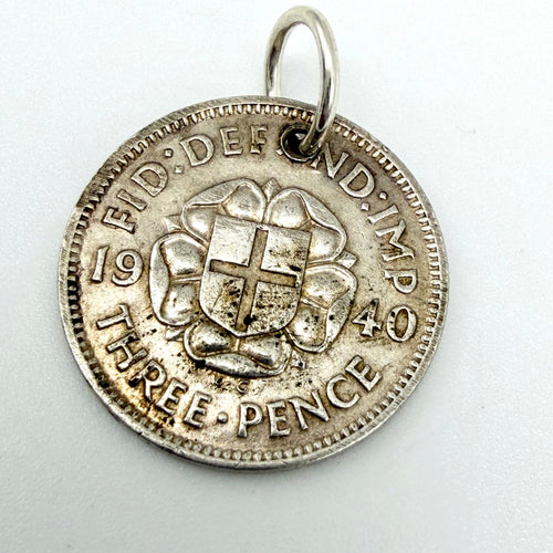 Angled view of the rose and shield side of the 1940 threepence coin charm